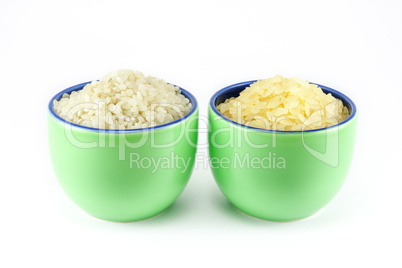 Two varieties of rice inside two cups of coffee