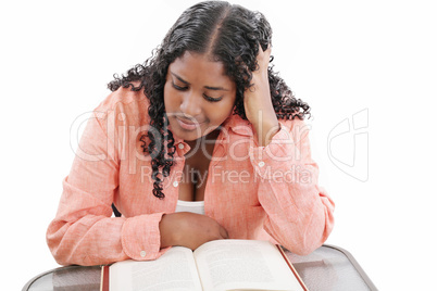 High school or college ethnic African-American female student sitting by the desk