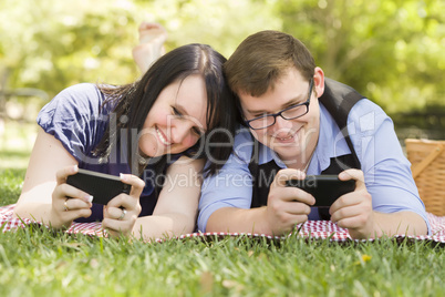 Young Couple at Park Texting Together