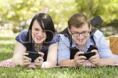 Young Couple at Park Texting Together