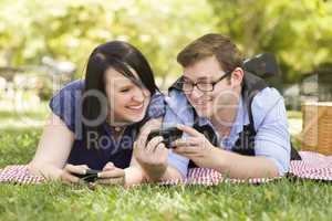 Young Couple at Park Texting Together