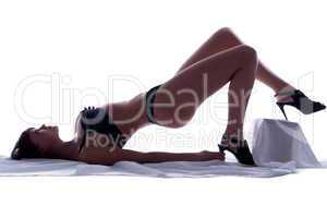 Woman in underwear lying on sheet