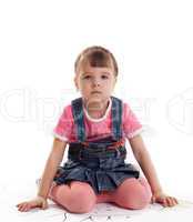 Little girl sitting on floor