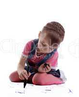 Cute little girl drawing on floor