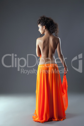 Beautiful young woman in long orange skirt