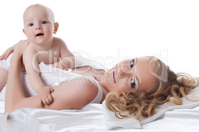 Happy mother and baby in bed