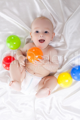 Happy baby with colored balls