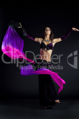 Beautiful young woman dancing oriental dance