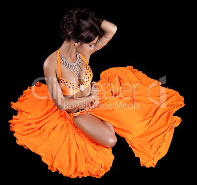 Sexy oriental dancer in orange costume