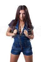 Sexy brunette young woman in denim overalls
