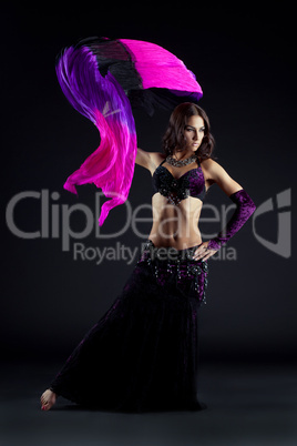 Pretty young woman dancing oriental dance