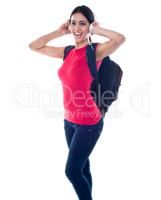 College girl enjoying music through headphones