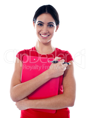 Pretty teenager holding folder and pen