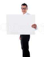 Smiling guy holding banner ad with one hand