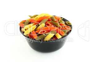 Colored pasta in black bowl