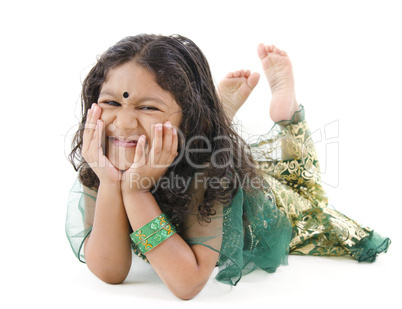 Little Indian girl lying on floor