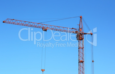 red crane and blue sky on building site