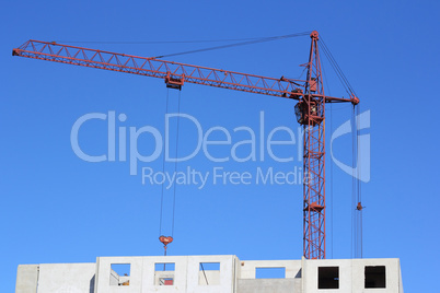 red crane and blue sky on building site