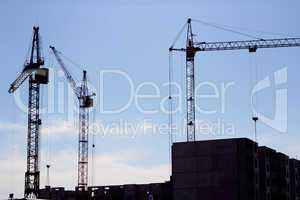 crane and blue sky on building site
