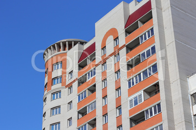 The inhabited high house against the blue sky