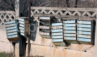 Old mailboxes are on the fence