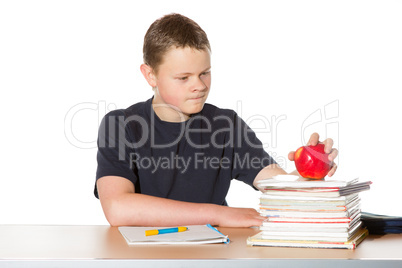 Teenager contemplating a ripe red apple