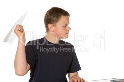 Teenager taking aim with a paper plane