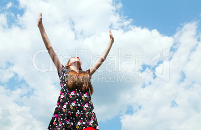 Teen girl with raised hands
