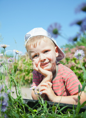 Small boy laying on the grass