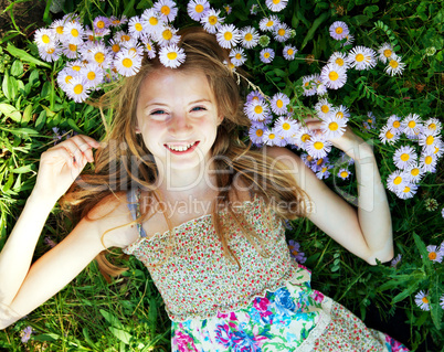 Teen girl lying in grass