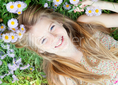 Teen girl laying in grass