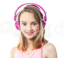 Attractive girl wearing pink headphones