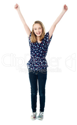 Excited school girl with raised arms