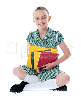 Beautiful girl holding school books