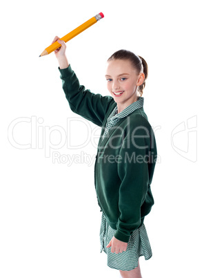 Attractive little girl writing in copy space area