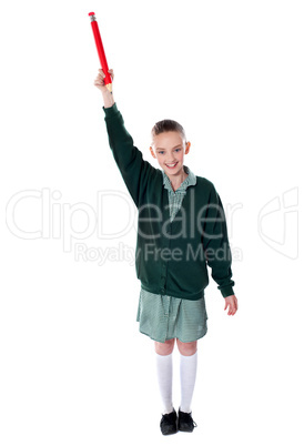 Beautiful girl holding big pencil over her head