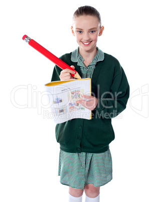 Beautiful girl drawing on her text book