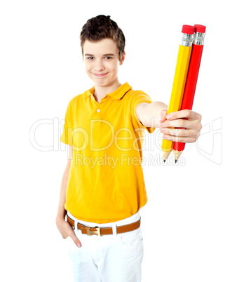 Stylish boy showing two large pencils