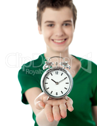 Adorable boy with a alarm clock