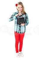 Smiling girl holding clapperboard