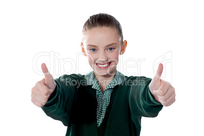 Little girl showing thumbs up to camera