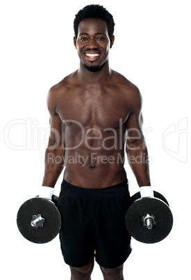 Attractive man posing with dumbbells