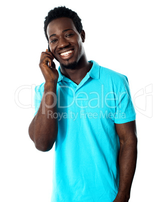 Casual young man communicating on phone