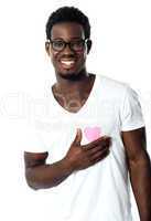 Handsome man holding paper heart