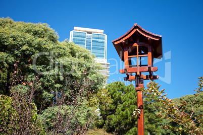 Japanese lantern on a background of blue sky and the skyscraper
