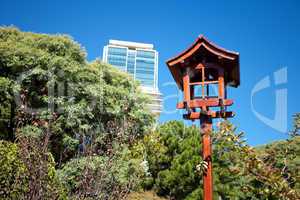 Japanese lantern on a background of blue sky and the skyscraper