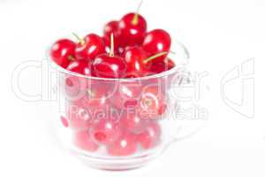 glass cup with cherries on a white background
