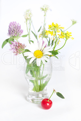 bouquet of wild flowers and cherry with green leaf