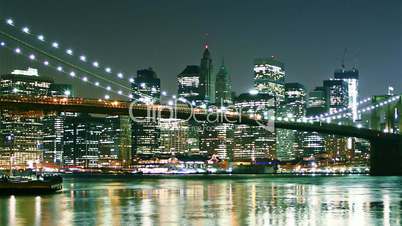 Beautiful view of Manhattan skyline and Brooklyn bridge at night. Time lapse and loopable