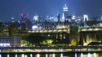 New York skyline and Manhattan bridge at night. Time lapse and loopable